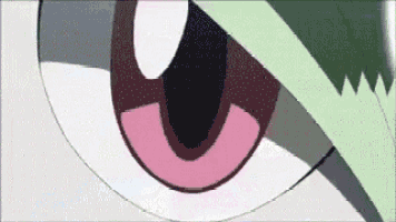 a close up of a cartoon character 's eye with a green leaf on it .