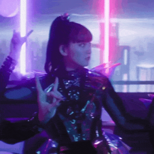 a woman in a futuristic outfit is dancing in front of neon lights