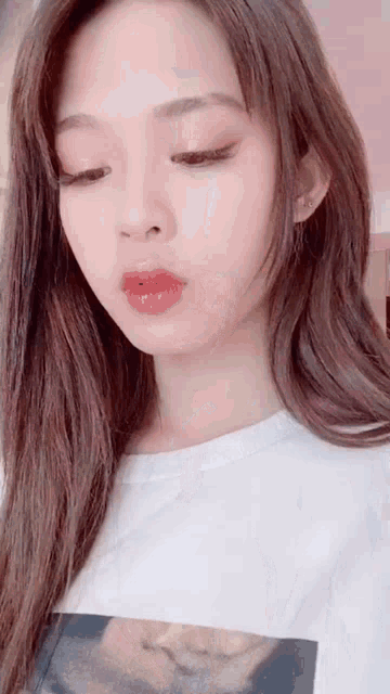 a close up of a woman 's face with her eyes closed .