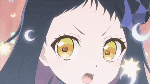 a close up of a girl 's face with crescent moons and stars around her