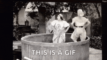 two women are standing in a wooden tub with the words `` this is a gif '' .