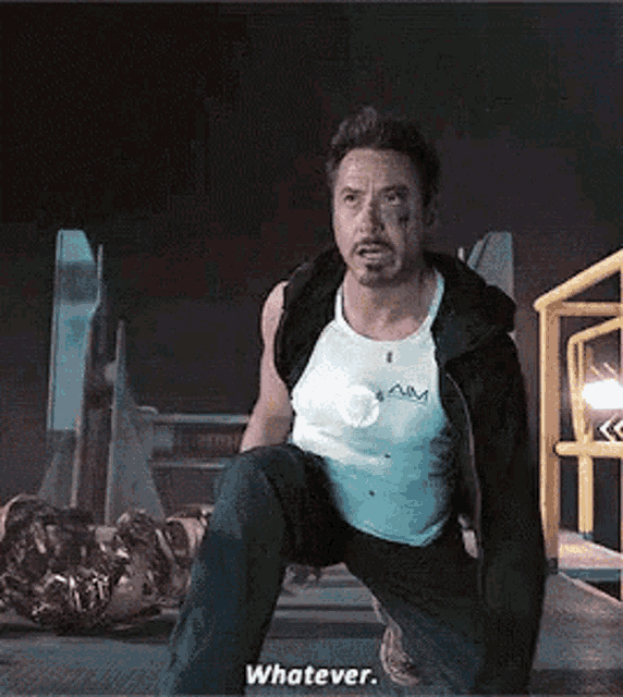 a man is kneeling down and saying `` whatever '' .