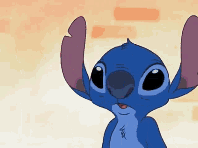 a close up of a stitch cartoon character with a brick wall in the background