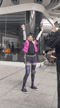 a person taking a picture of a girl in a purple costume