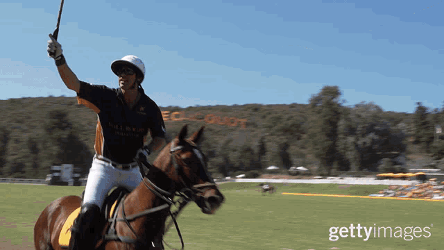 a man riding a horse in front of a sign that says " equinox "