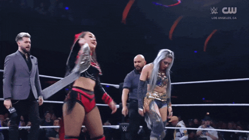 two women in a wrestling ring with a cw logo on the bottom