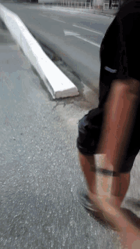a person 's legs are visible in a blurry photo while walking down a street