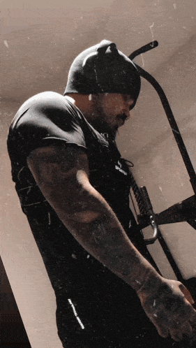 a man wearing a black shirt with the word reebok on the sleeve