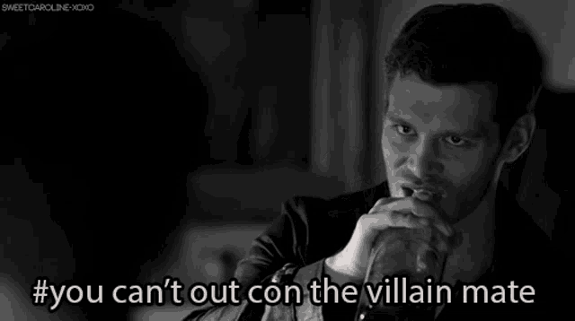 a black and white photo of a man with #you can 't out con the villain mate