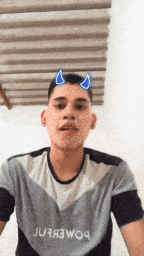 a young man with devil horns on his head wears a shirt that says juja3woa
