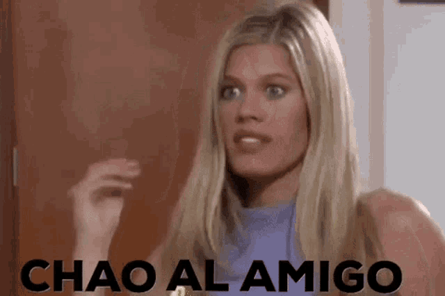 a woman is standing in front of a door and the words chao al amigo are on the screen