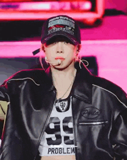 a woman wearing a hat and a leather jacket with the number 99 on it .