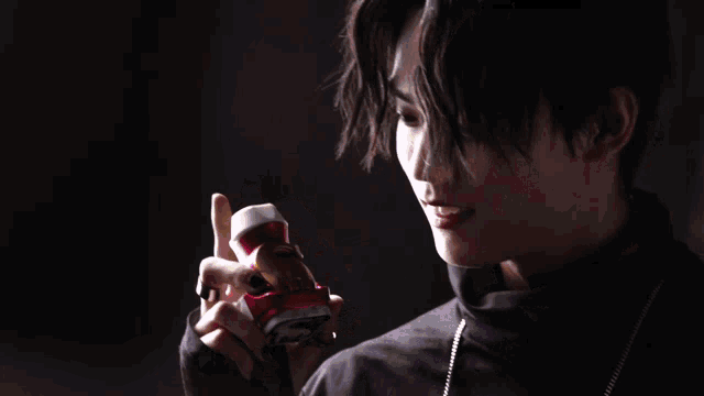 a person holding a can of soda that says coca cola on it