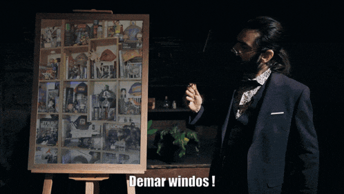a man in a suit stands in front of a display board that says ' demar windos '