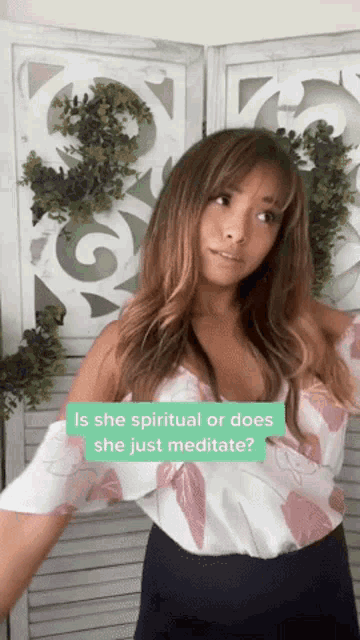 a woman is standing in front of a screen with a question mark that says is she spiritual or does she just meditate
