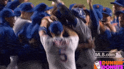 a bunch of baseball players are huddled together with a dunkin donuts logo in the background