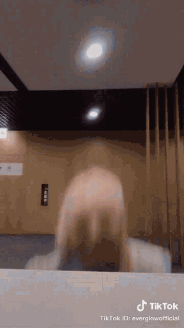 a woman 's head is visible in a tiktok video taken by everglowofficial