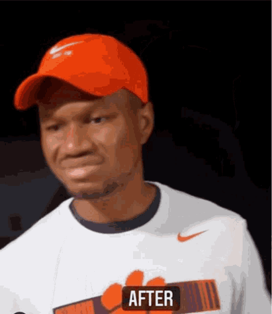 a man wearing an orange hat and a white shirt with the word after on the bottom