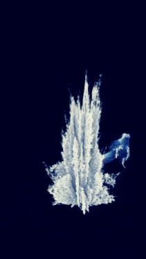 a large splash of water is coming out of the ground