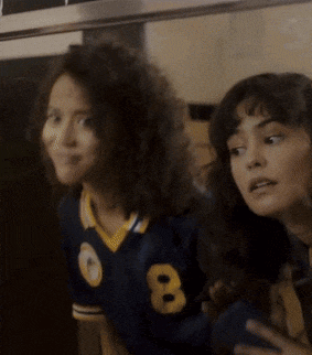 two women are standing next to each other and one of them is wearing a jersey with the number 8 on it