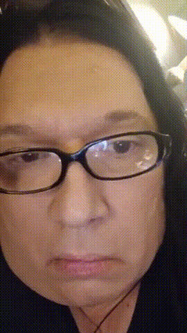 a close up of a woman 's face with glasses and headphones