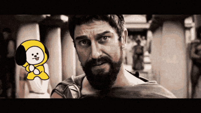 a man with a beard is standing next to a small yellow dog
