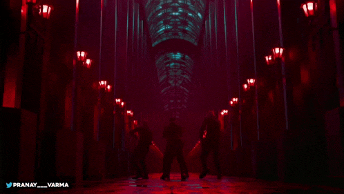 a group of people are dancing in a dark hallway with the name pranay varma on the bottom right
