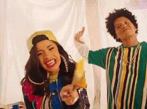 a man and a woman are dancing together in a room . the woman is holding a banana .