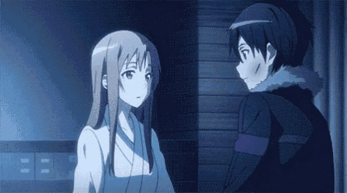 a boy and a girl are standing next to each other in a room and looking at each other .