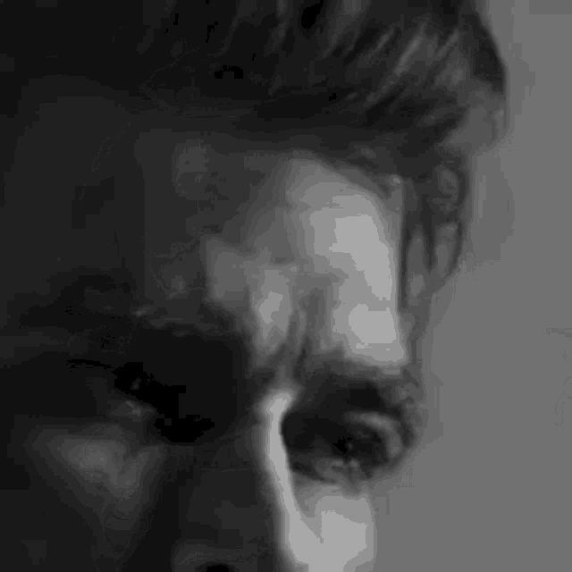 a black and white photo of a man 's face .