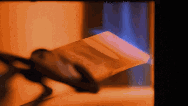 a blurry picture of a person holding a piece of paper in front of a window
