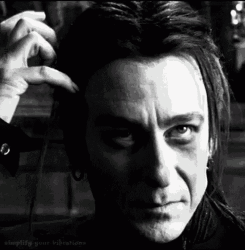 a black and white photo of a man 's face with the words simplify your vibrations on the bottom right