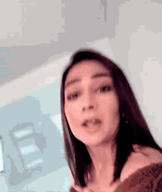a close up of a woman 's face with a blurred background .