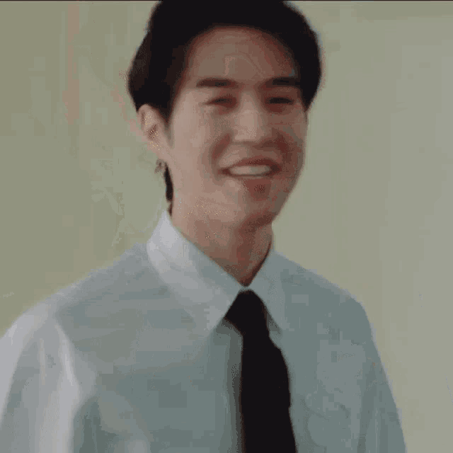 a man in a suit and tie is pointing at the camera with the words `` let 's go '' written on it .