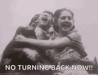 a black and white photo of two women hugging each other with the words `` no turning back now '' .