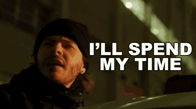 a man in a black hat says i 'll spend my time in white letters