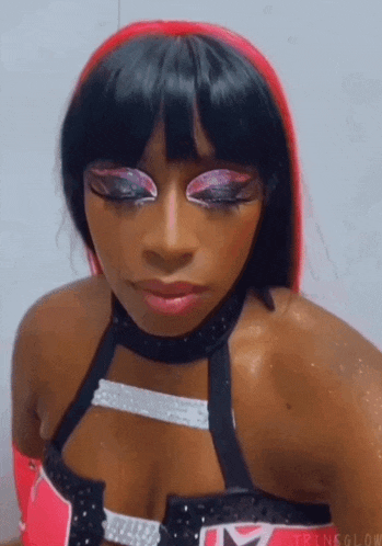 a close up of a woman 's face with a lot of makeup on .
