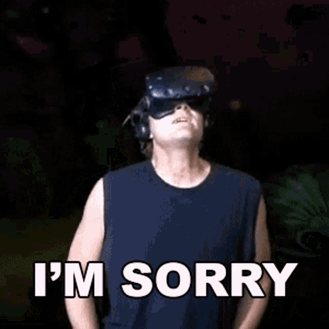 a man wearing a virtual reality headset is saying sorry
