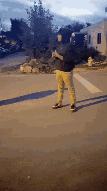 a person standing on a street with a fire hydrant in the foreground