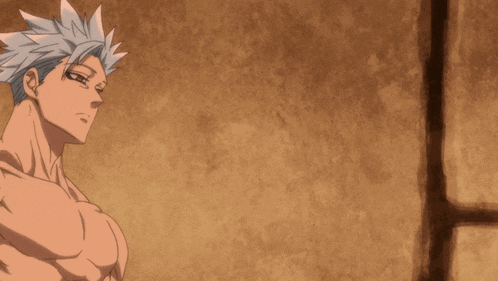 a man without a shirt is standing in front of a brick wall