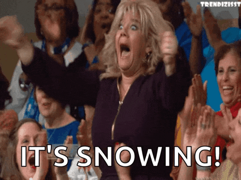 a woman in a crowd of people says it 's snowing !