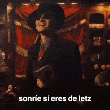 a man with red hair and wings is smiling with the words sonrie si eres de letz above him