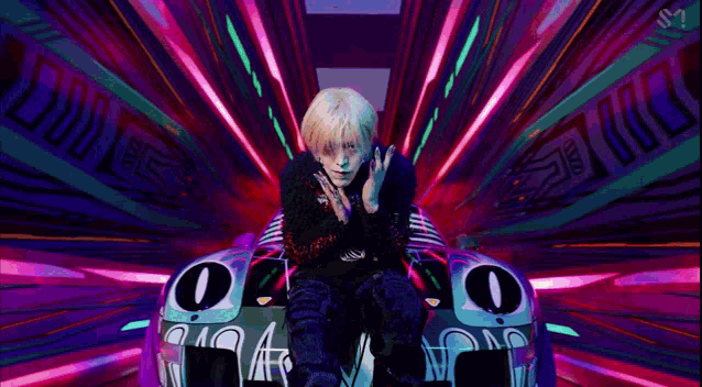 a person is sitting in a car in a tunnel with a purple background .