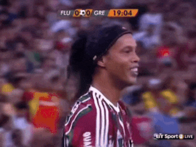 a soccer player wearing a headband is smiling in front of a crowd during a game