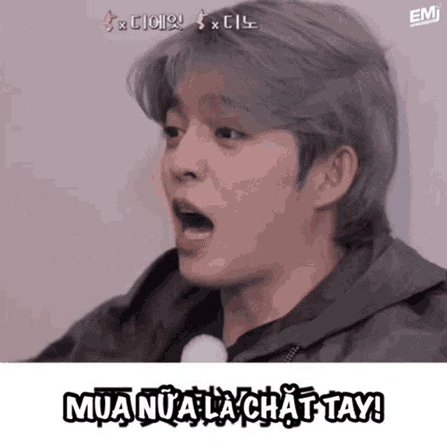 a man with gray hair is making a funny face with his mouth open and the words mua nua la chat tay written below him .