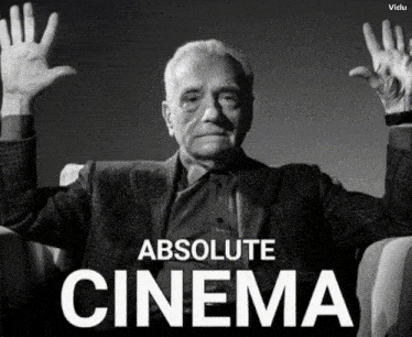 a man sitting in a chair with his hands in the air and the words absolute cinema behind him
