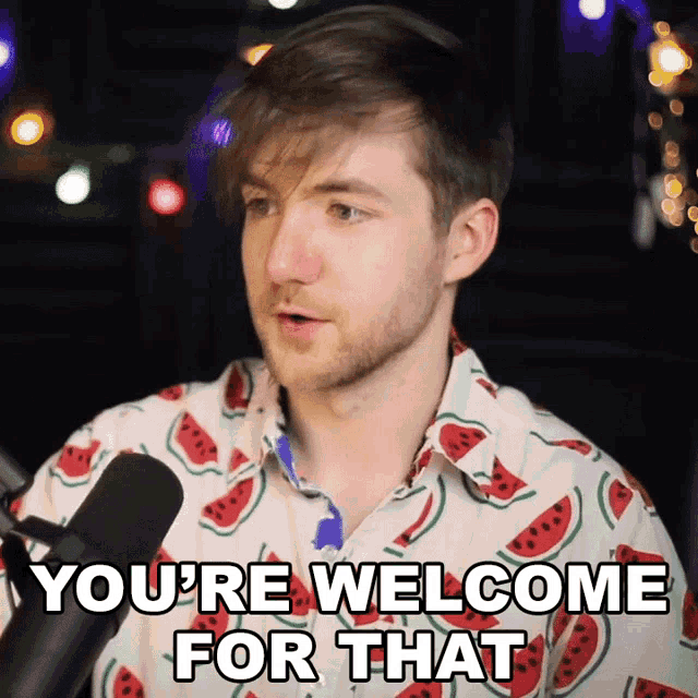 a man in a watermelon shirt says " you 're welcome for that " in front of a microphone