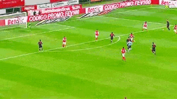 a group of soccer players are playing a game on a field