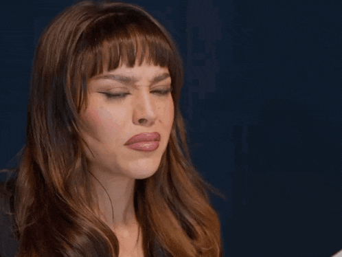 a close up of a woman 's face with her eyes closed