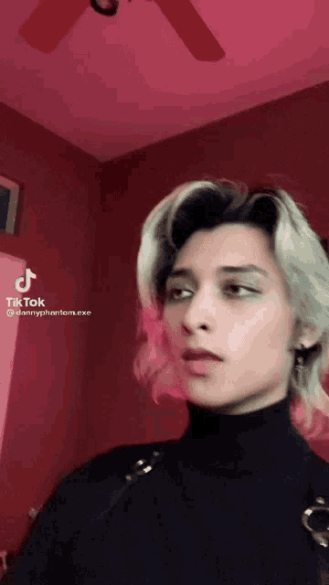 a woman 's face is shown in a tik tok video with a red background